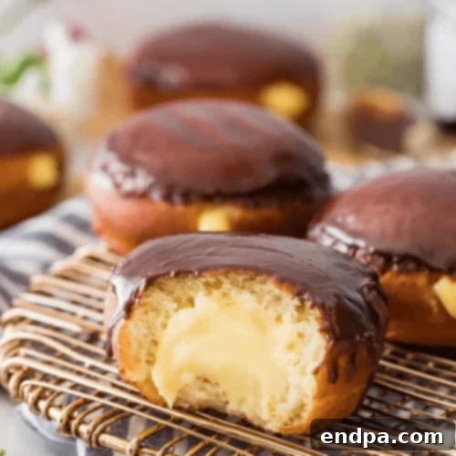 Boston Cream Donuts filled with custard and topped with chocolate glaze.