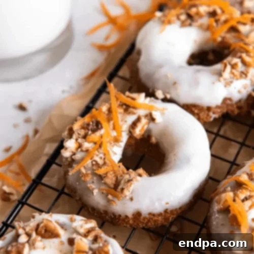 Baked Carrot Cake Donuts with cream cheese frosting and chopped nuts.