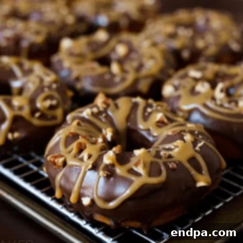 Chocolate Caramel Pecan Turtle Donuts, decadent and garnished with nuts and caramel.