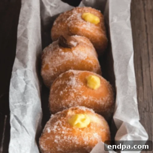 Bomboloni, Italian-filled donuts, rolled in sugar and filled with cream.