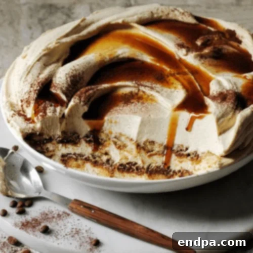 An elegant Espresso Martini Tiramisu, dusted with cocoa powder and garnished with coffee beans.