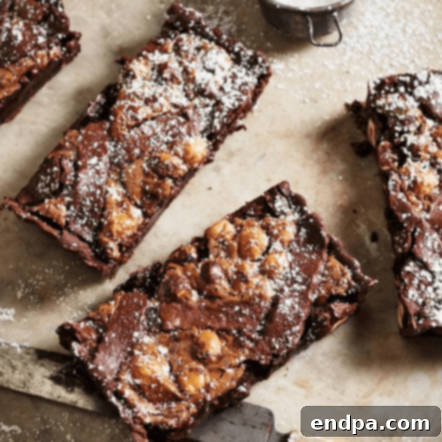 A luxurious Chocolate, Hazelnut, and Frangelico Tart, beautifully sliced and ready to serve.