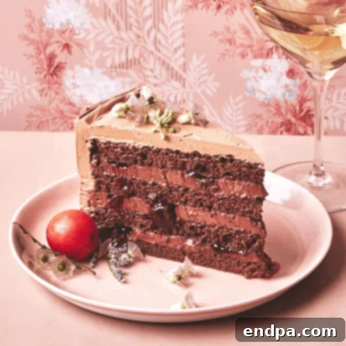 A stunning Black Forest Layer Cake, generously adorned with cherry preserves and chocolate shavings.