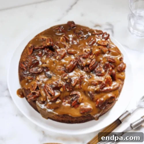 An elegant Toasted Pecan Torte, drizzled generously with a golden butterscotch topping.