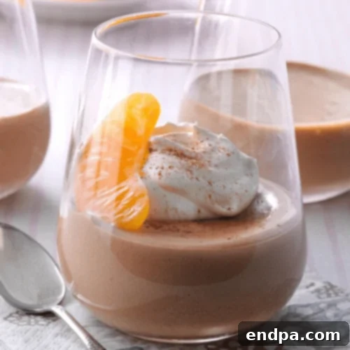 An elegant slice of Tangerine Chocolate Semifreddo, garnished with orange segments and chocolate shavings.