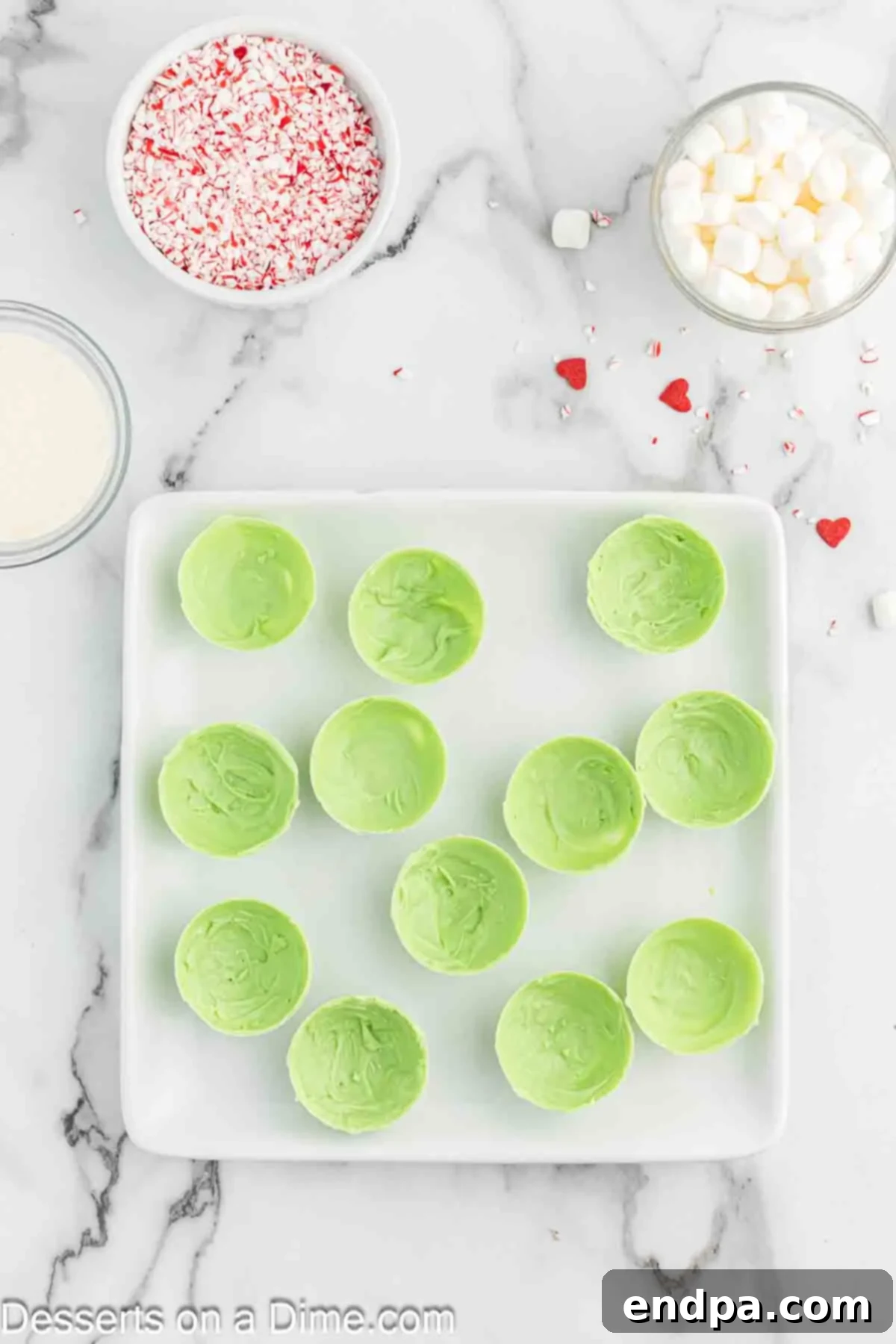 Grinchmas Hot Cocoa Bombs 6 Hardened chocolate bomb halves gently removed from molds on a plate.