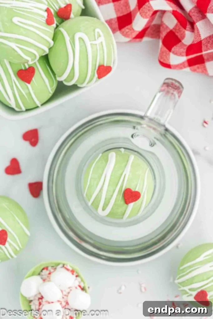 Grinchmas Hot Cocoa Bombs 10 A Grinch Hot Chocolate Bomb fully melted in a mug, creating a festive green hot chocolate.