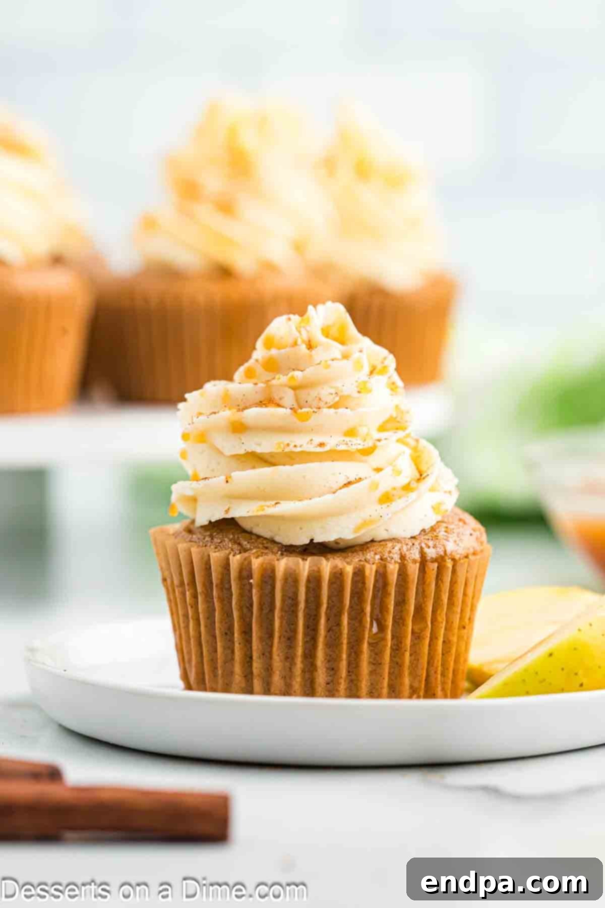 Sticky Caramel Apple Swirl Cupcakes 4 A close-up of a caramel apple cupcake with rich caramel frosting, ready to be enjoyed.