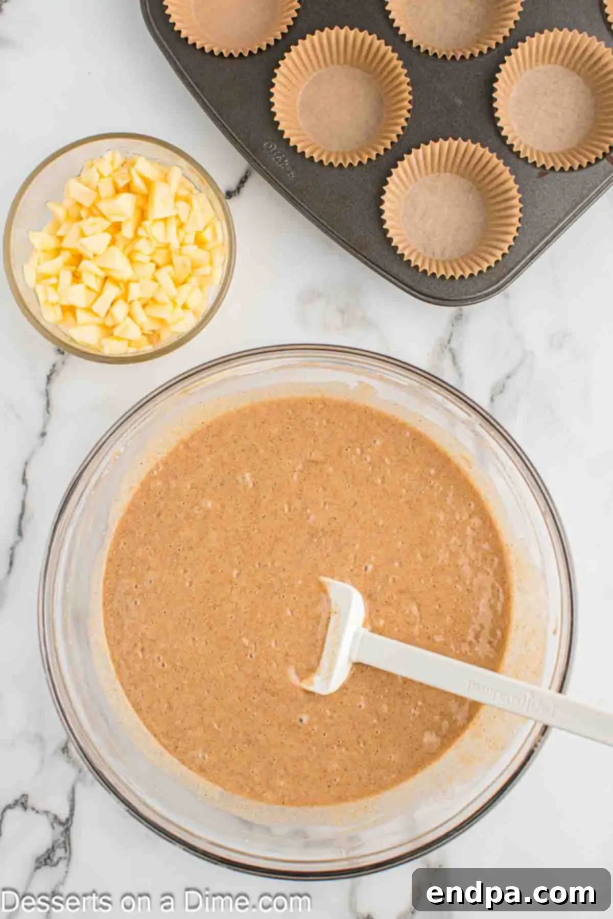 Sticky Caramel Apple Swirl Cupcakes 5 Mixing bowl with cake mix ingredients combined, ready for apples.
