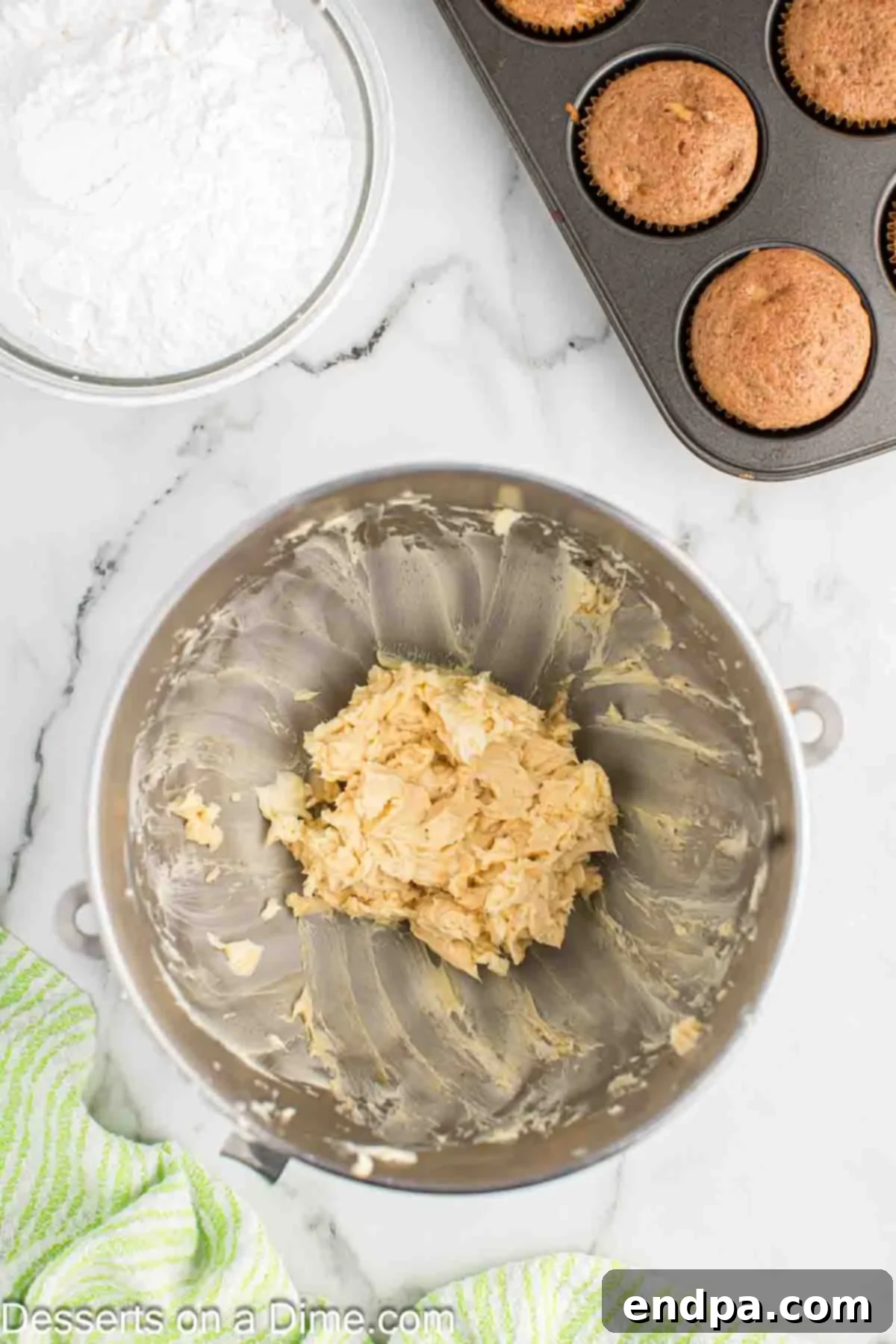 Sticky Caramel Apple Swirl Cupcakes 9 Mixing bowl with caramel sauce and vanilla extract added to the beaten butter.