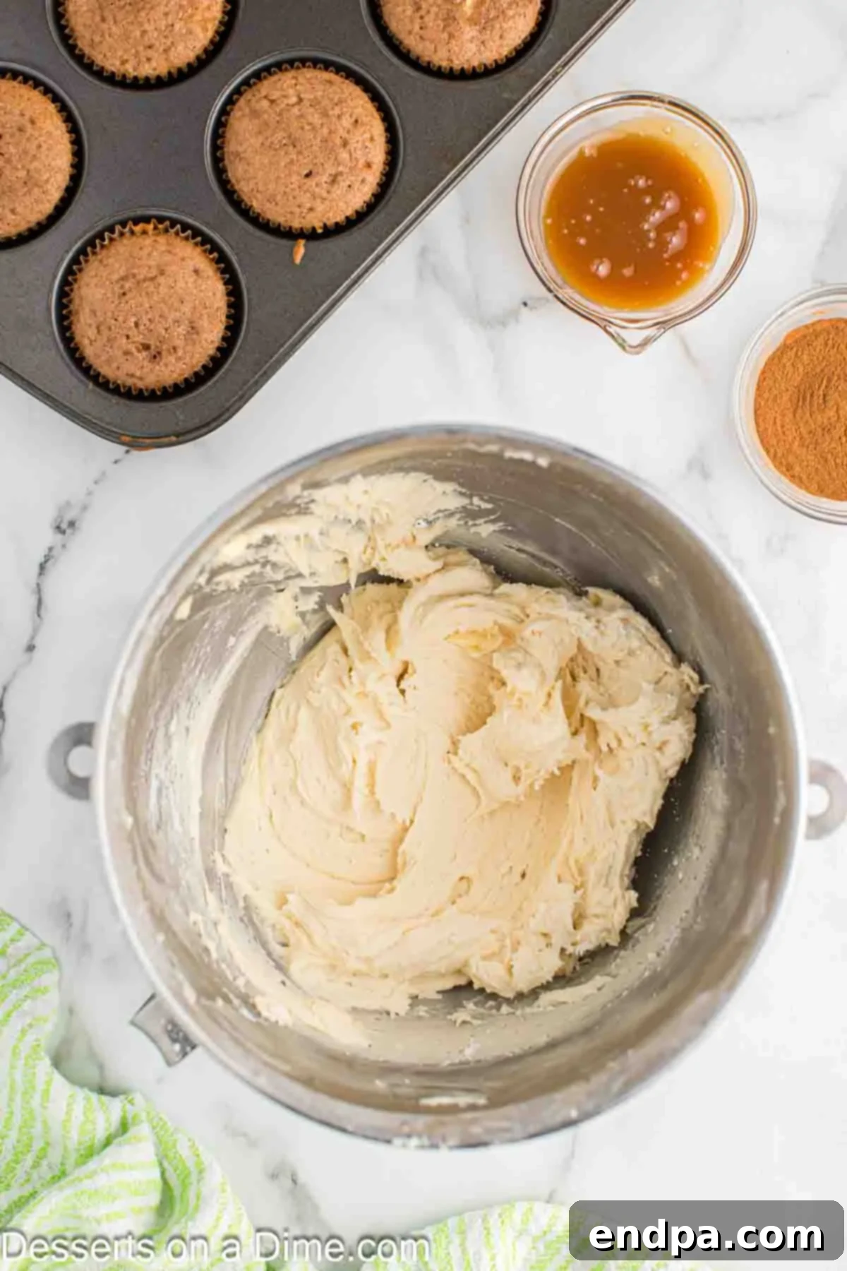 Sticky Caramel Apple Swirl Cupcakes 10 Mixing bowl with powdered sugar gradually added to the caramel butter mixture.