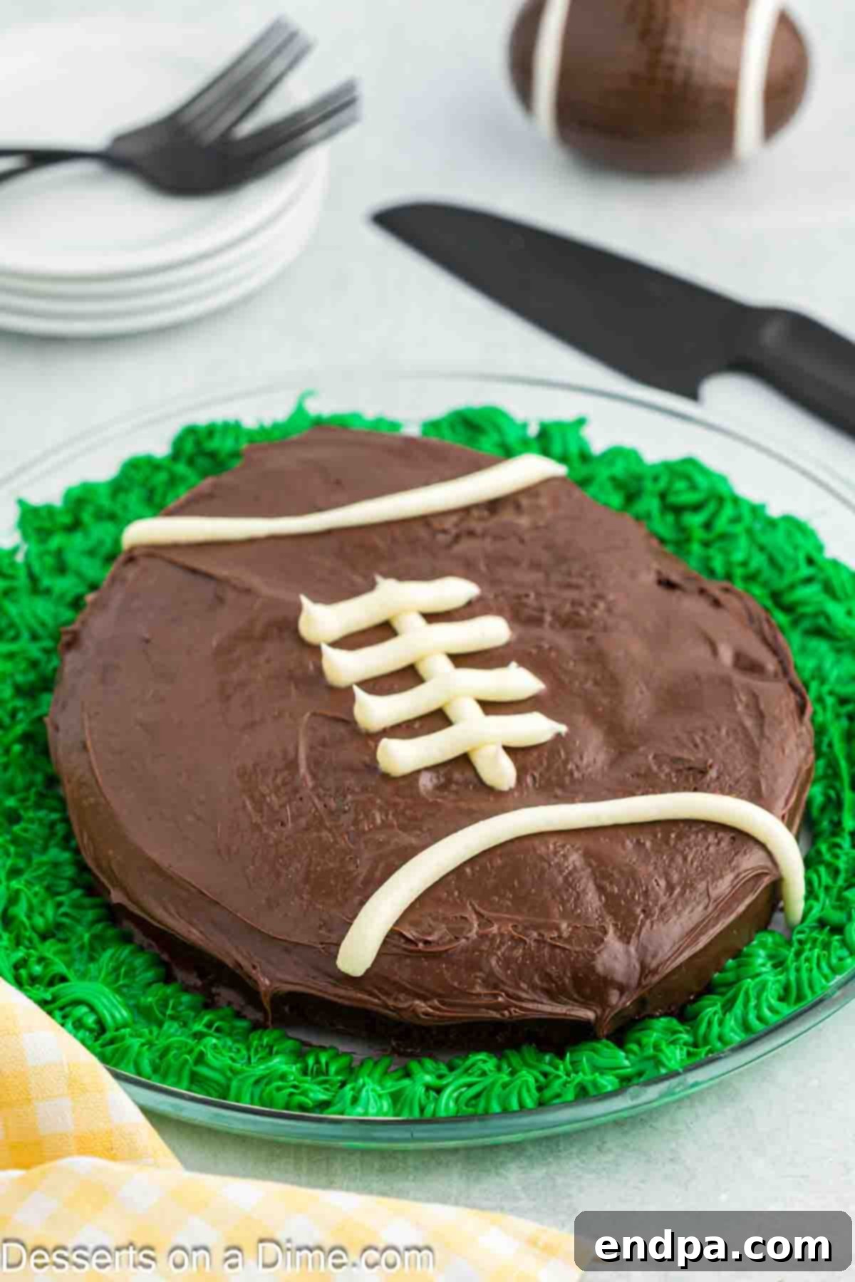 Game Day Goal: Baking a Winning Football Cake 2 Football cake on a platter, perfectly shaped and frosted.
