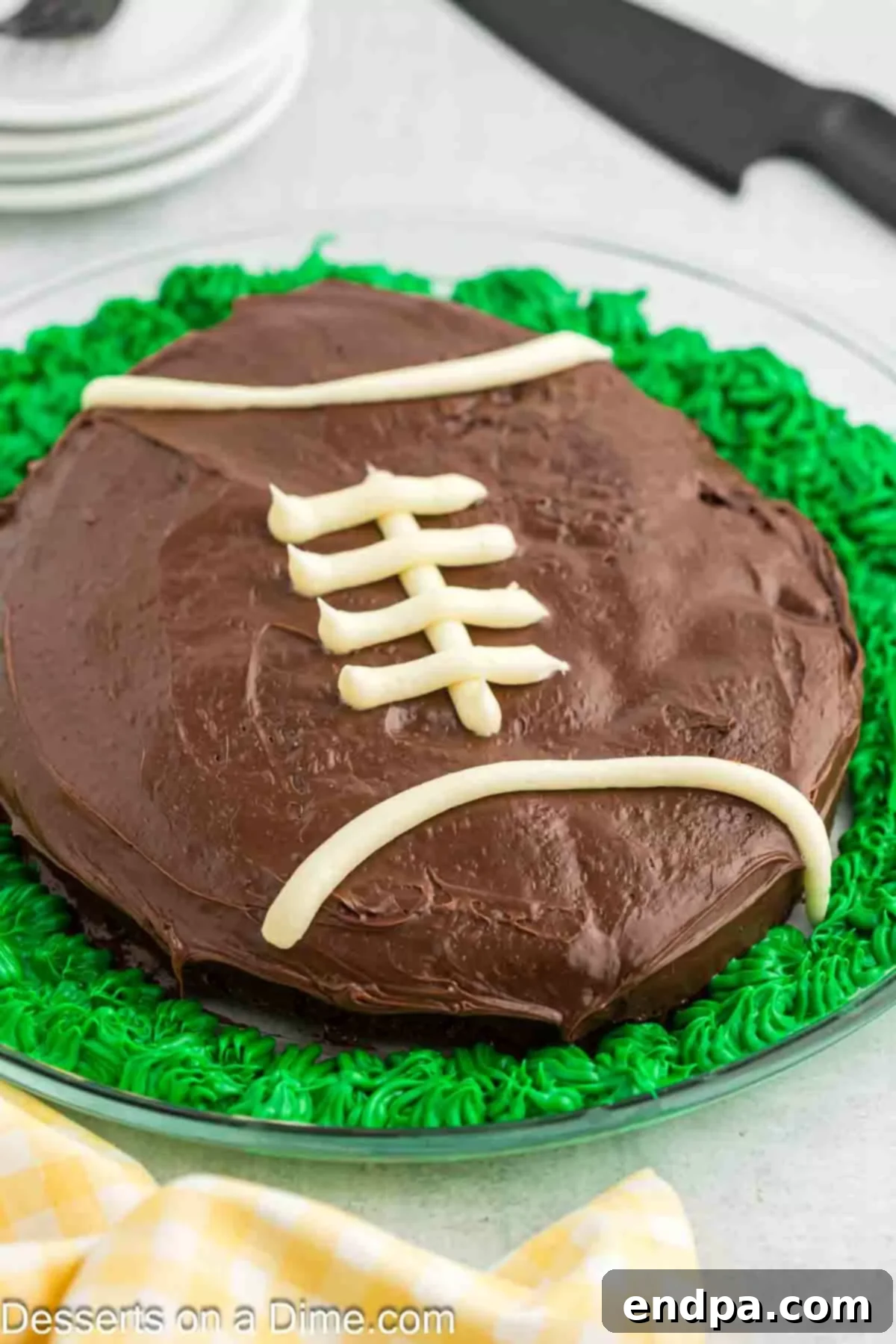 Game Day Goal: Baking a Winning Football Cake 11 Green icing around cake to look like grass.