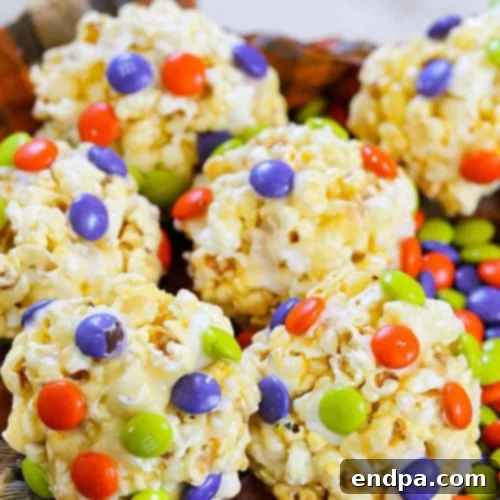 Fun and spooky Monster Popcorn Balls with edible eyes and colorful decorations.
