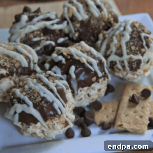S’mores Popcorn Balls, featuring chocolate, marshmallow, and graham cracker bits.