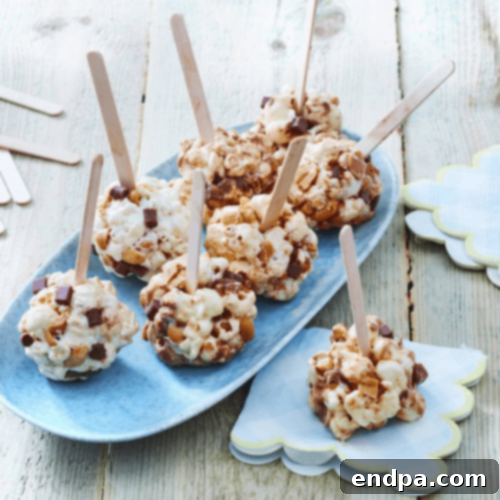 Rocky Road Popcorn Balls, combining chocolate, marshmallows, and nuts in a crunchy treat.