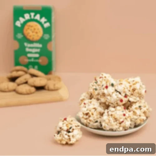 Vanilla Sugar Popcorn Balls, a simple and elegant treat with festive sprinkles.