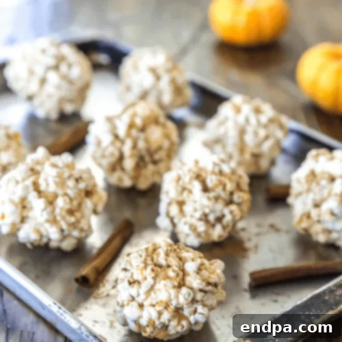 Cinnamon Bun Popcorn Balls, infused with warm cinnamon and sweet icing flavors.