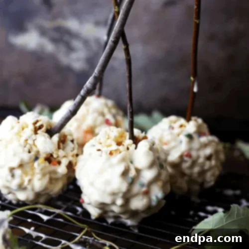Frosted Marshmallow Popcorn Balls, dipped in sweet frosting.
