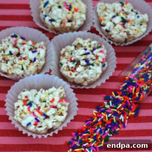 White Chocolate Funfetti Popcorn Balls, bursting with colorful sprinkles.