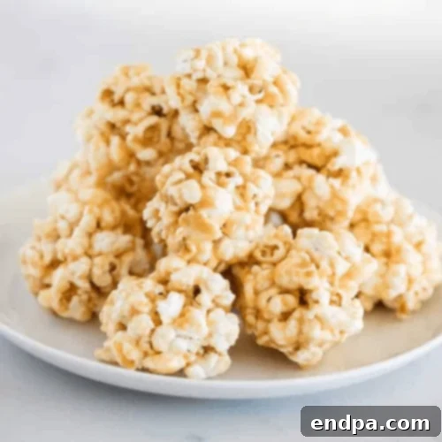 Golden Caramel Popcorn Balls, showcasing their gooey, sweet coating.