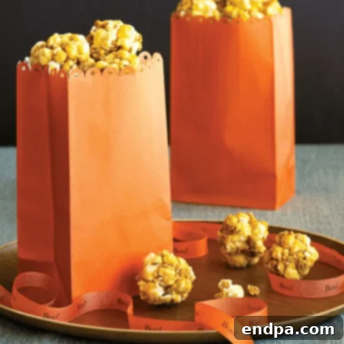Small, golden Honey Popcorn Balls, perfect for bite-sized snacking.