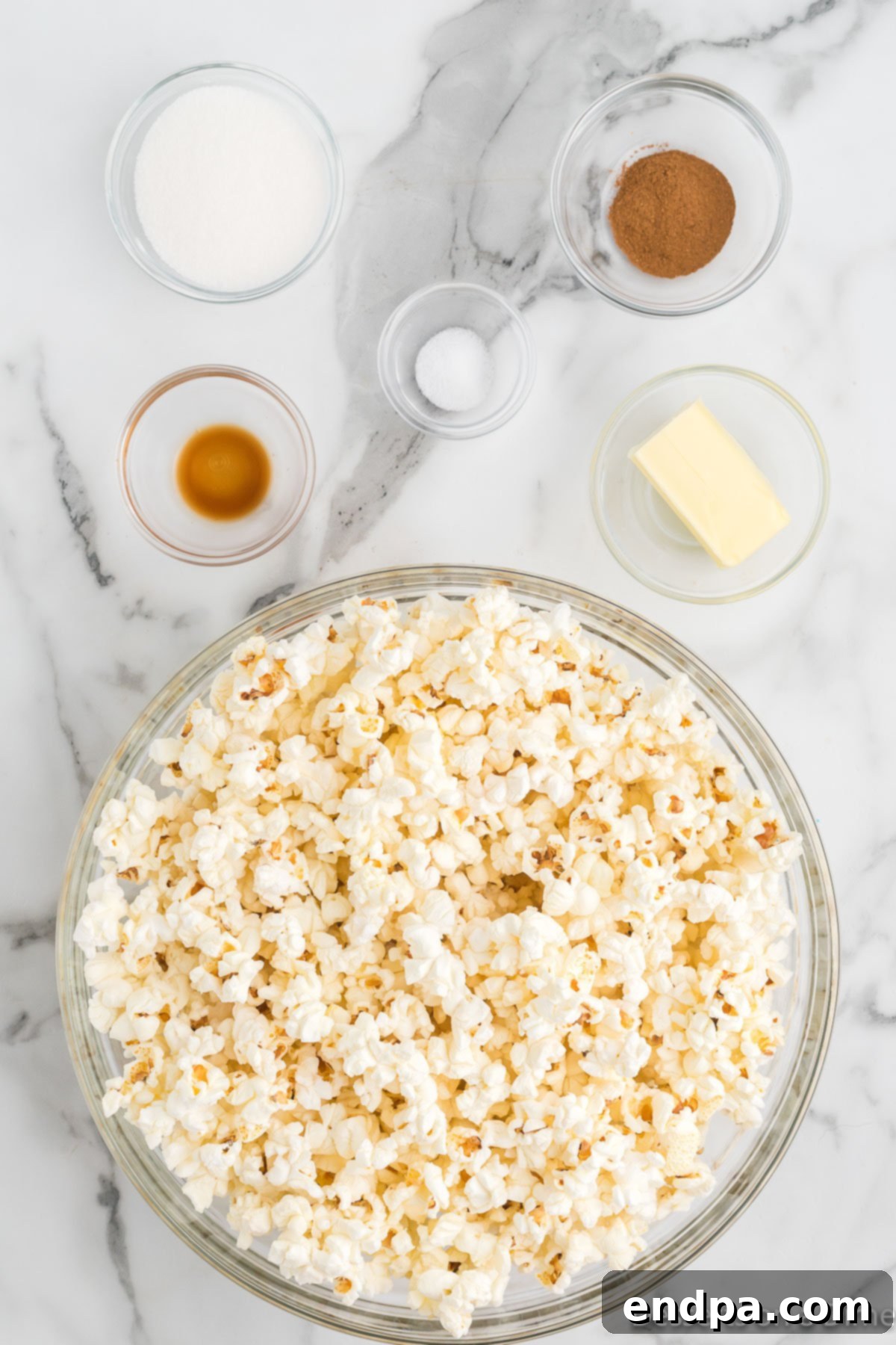 Ingredients for Pumpkin Popcorn including butter, salt, vanilla extract, and popcorn kernels.