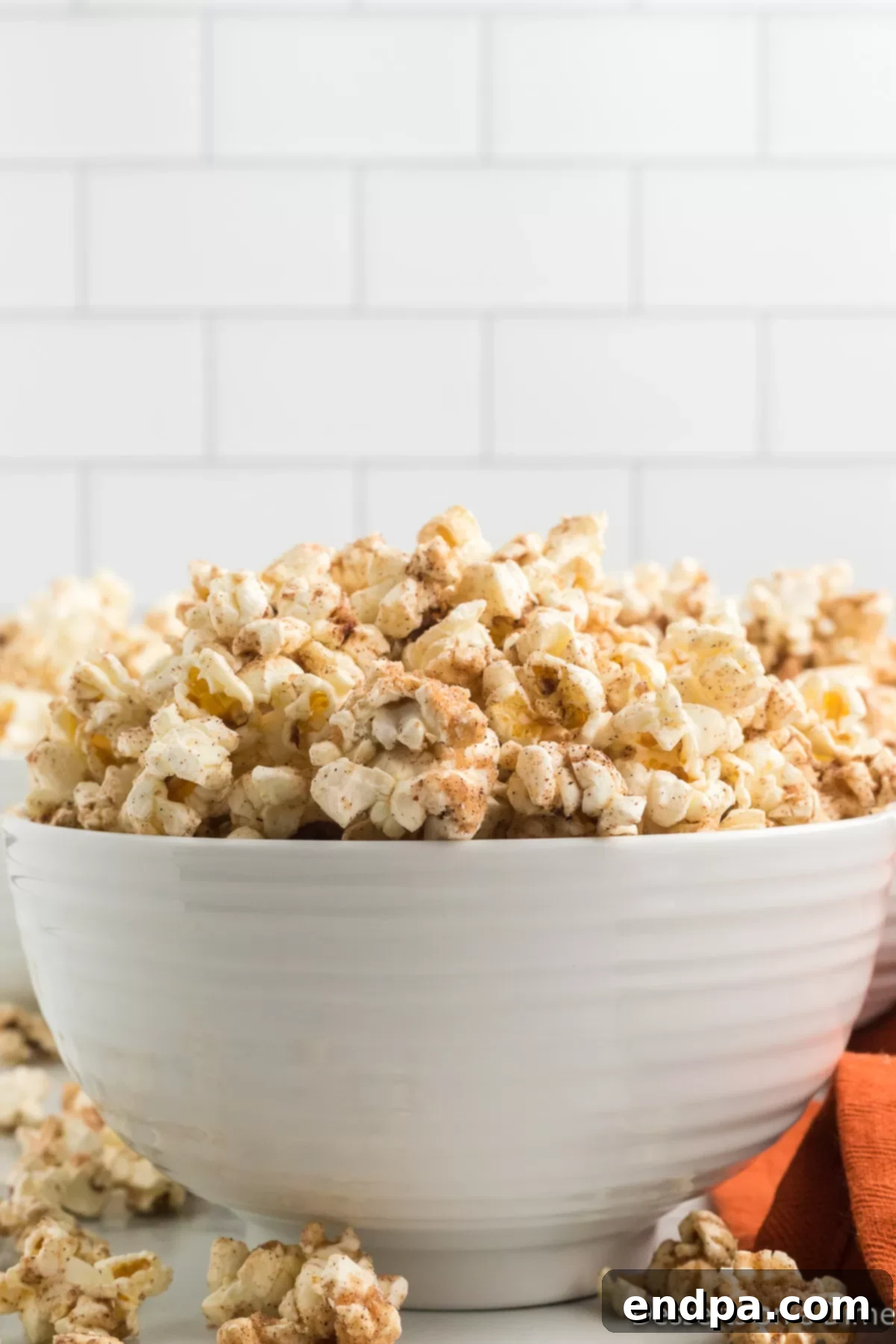 A beautifully presented bowl of homemade Pumpkin Spice Popcorn, perfect for a cozy autumn treat or seasonal gathering.