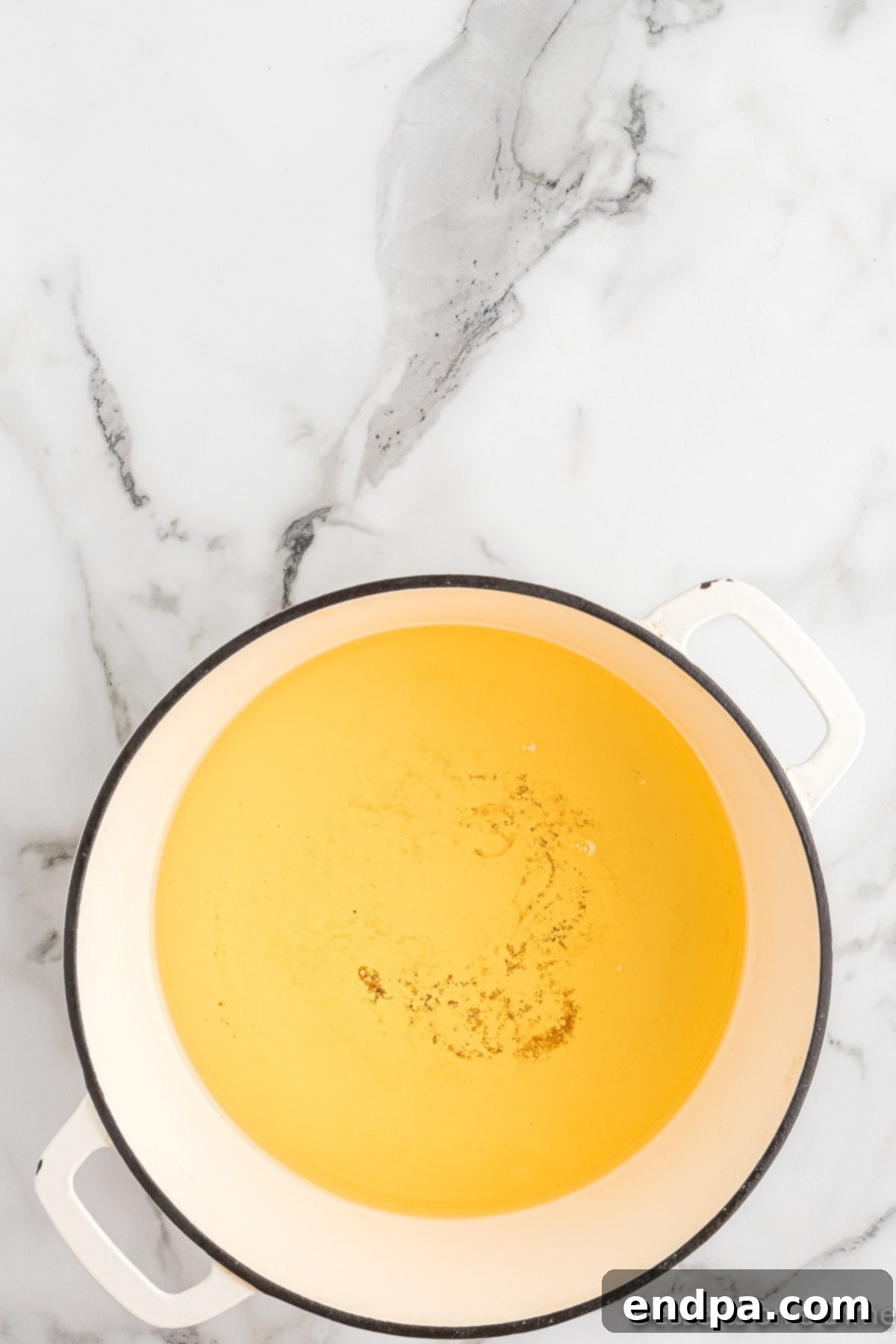 Vegetable oil heating in a large pot on the stovetop.
