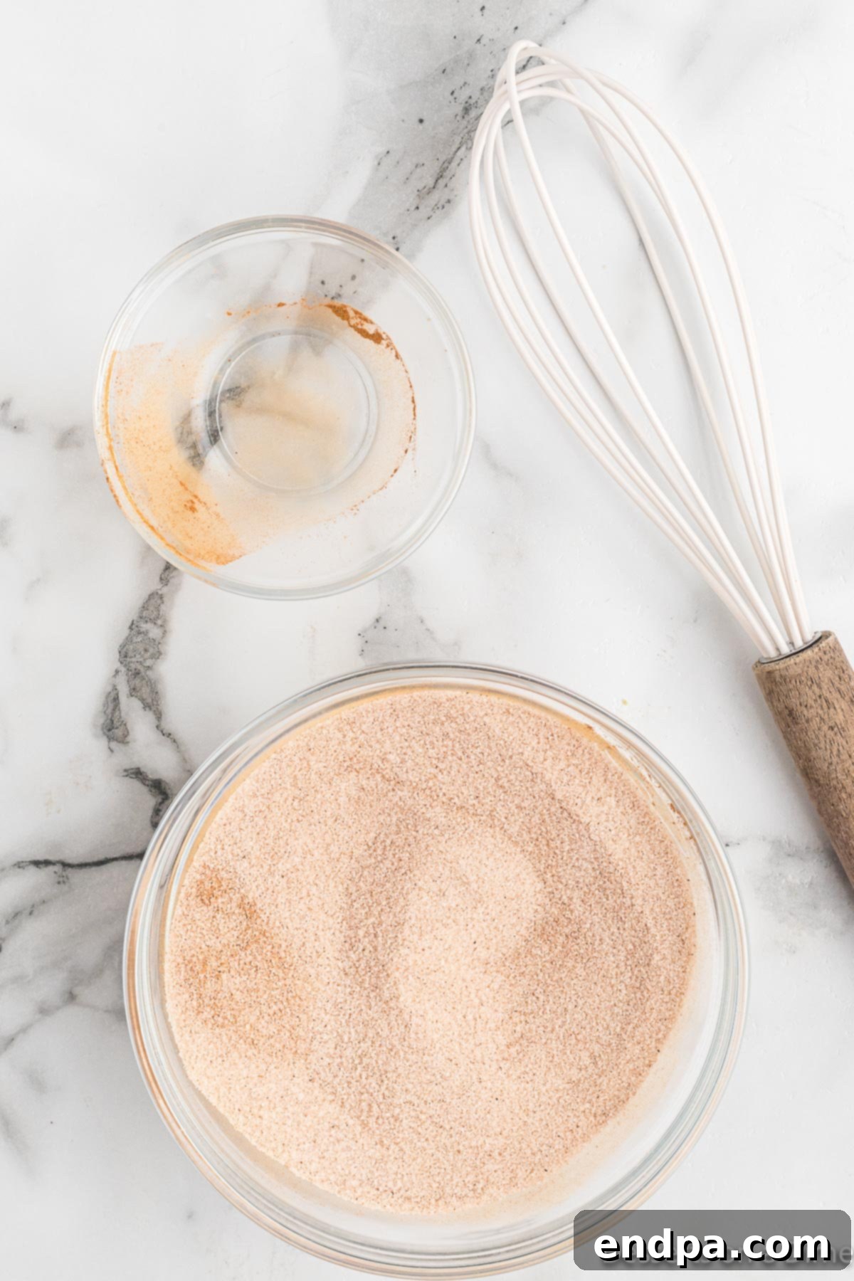 Granulated sugar and ground cinnamon whisked together in a separate small bowl.