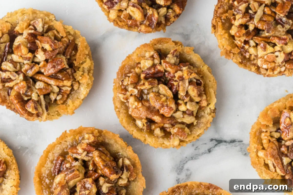 Pecan Pie in a Cookie 2 Delicious Pecan Pie Cookies arranged beautifully on a platter, ready to be served.