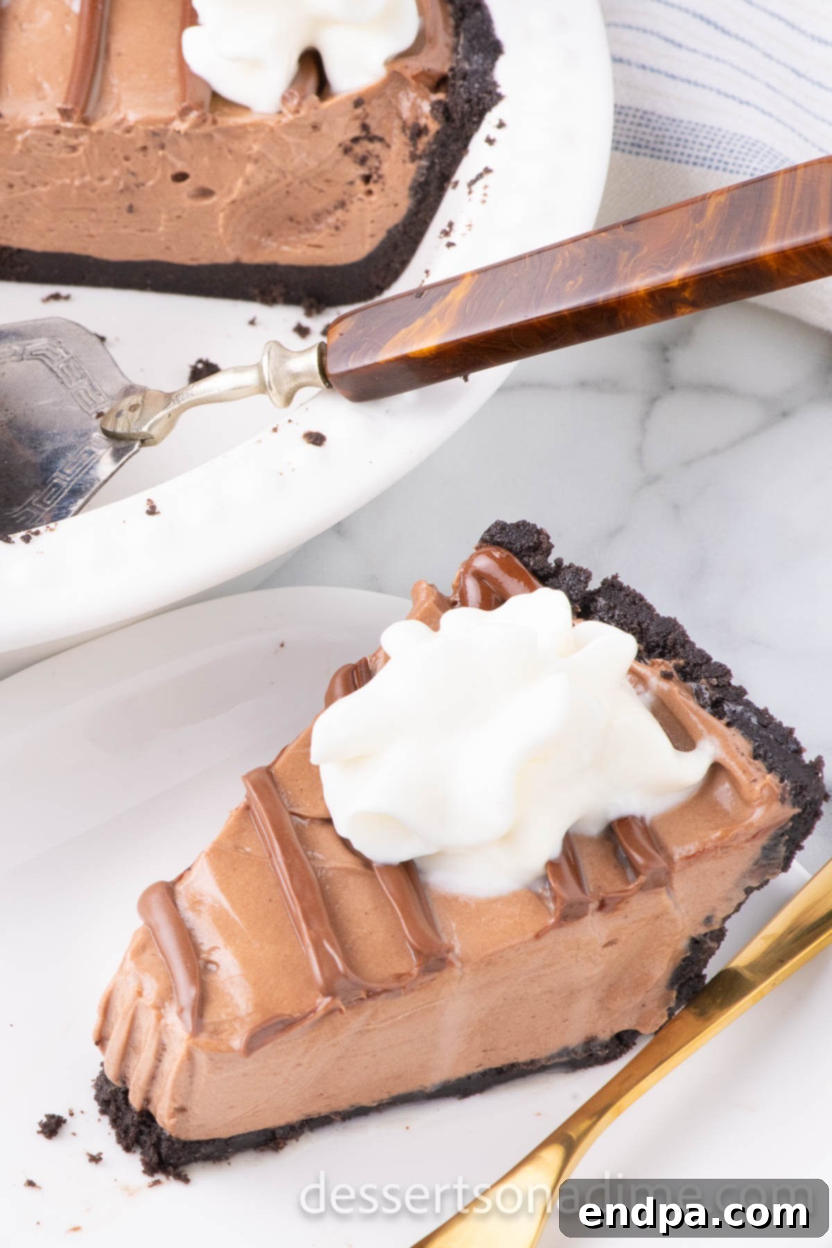 Decadent No Bake Nutella Cheesecake 2 A slice of creamy No Bake Nutella Cheesecake on a white plate, garnished with a drizzle of Nutella and a dollop of whipped cream, showcasing the rich texture and cookie crust.