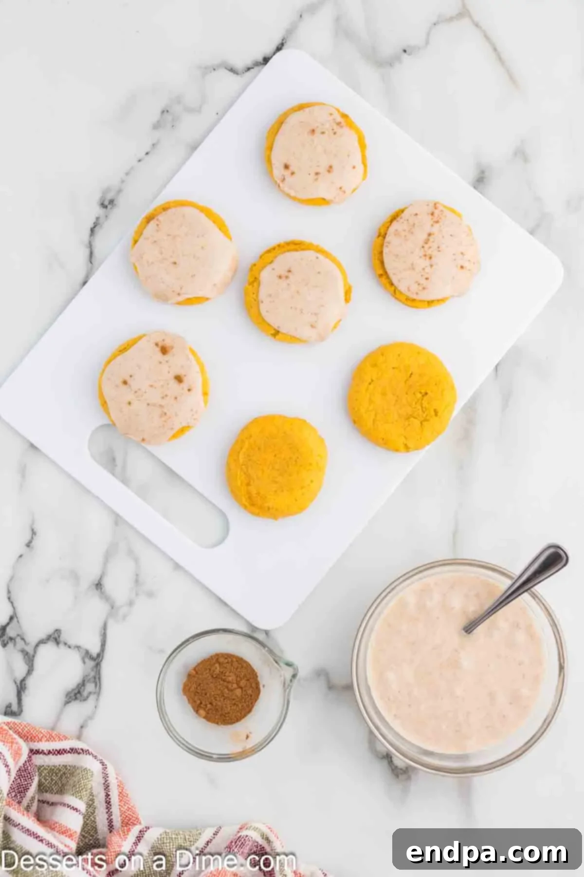 Ingredients for the glaze, including powdered sugar, milk, and pumpkin pie spice, blended together in a bowl until smooth and ready for application.