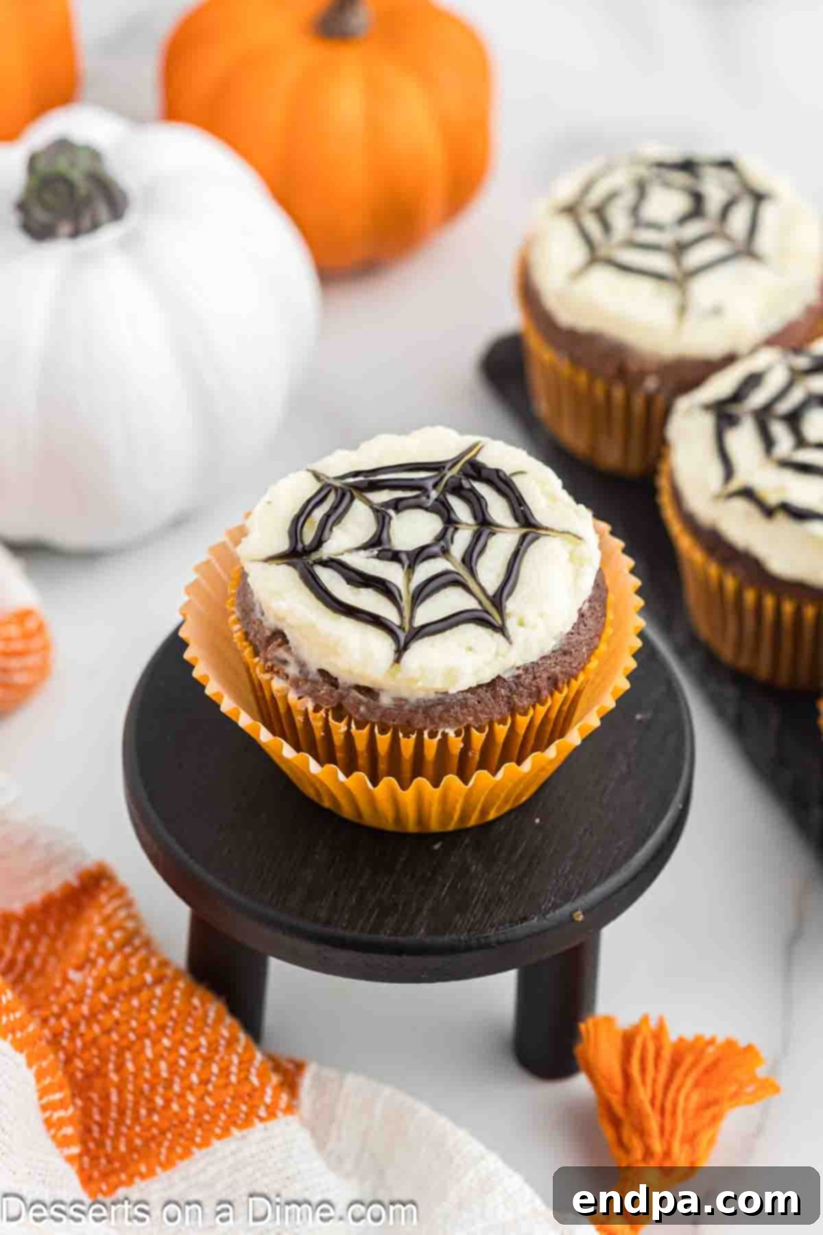 Delicious and spooky Spider Web Cupcakes, ready to serve at a Halloween party.
