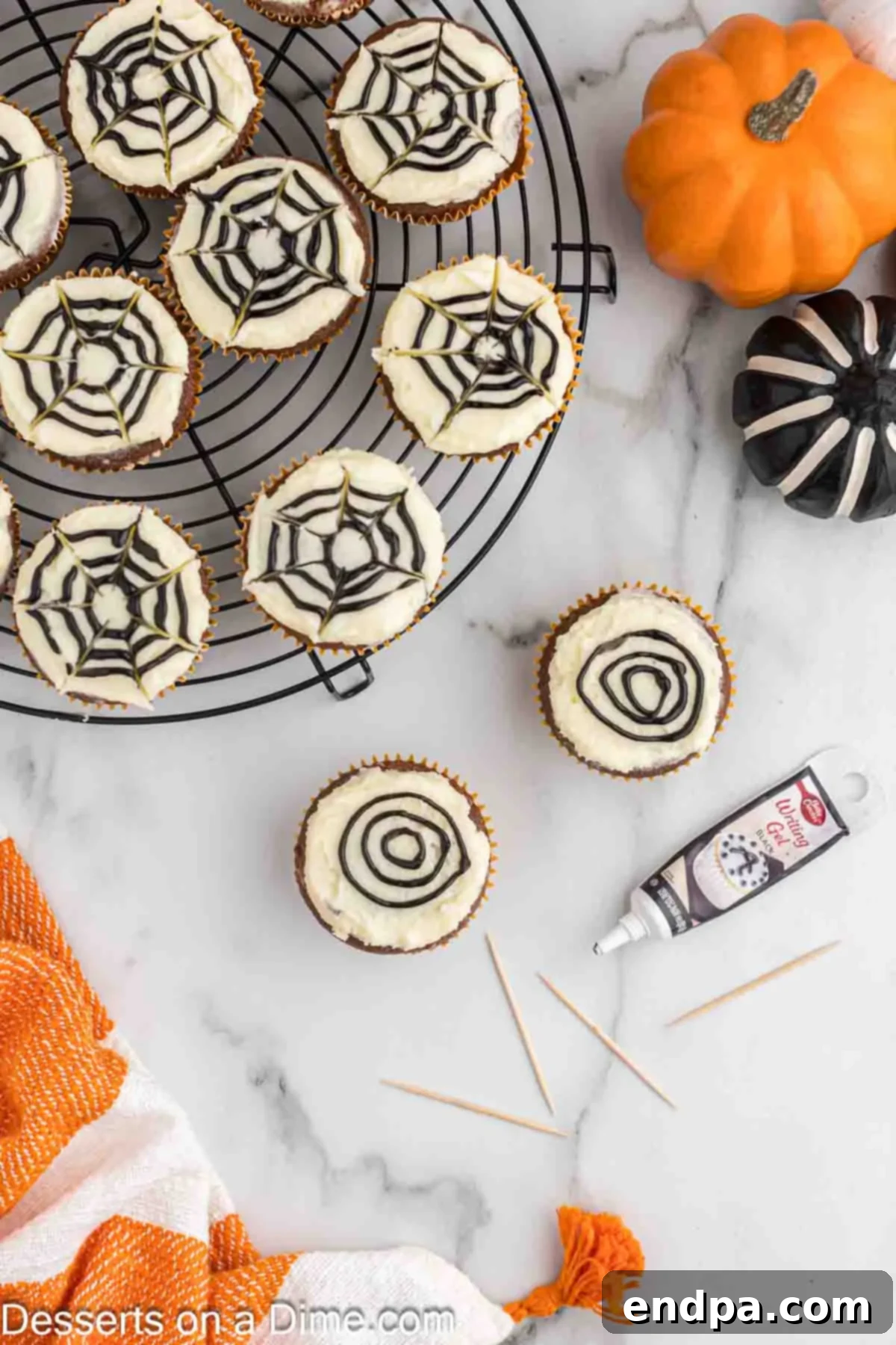 Three concentric circles of dark frosting piped onto the light frosting of a cupcake, forming the initial design for the Spider Web Cupcakes.