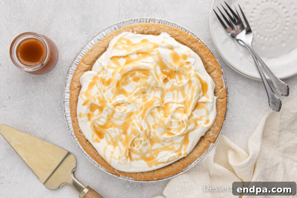 Golden Butterscotch Delight 2 A beautifully crafted Butterscotch Pie, generously topped with fluffy whipped cream, inviting a delightful dessert experience. The golden-brown crust holds a luscious, smooth filling.