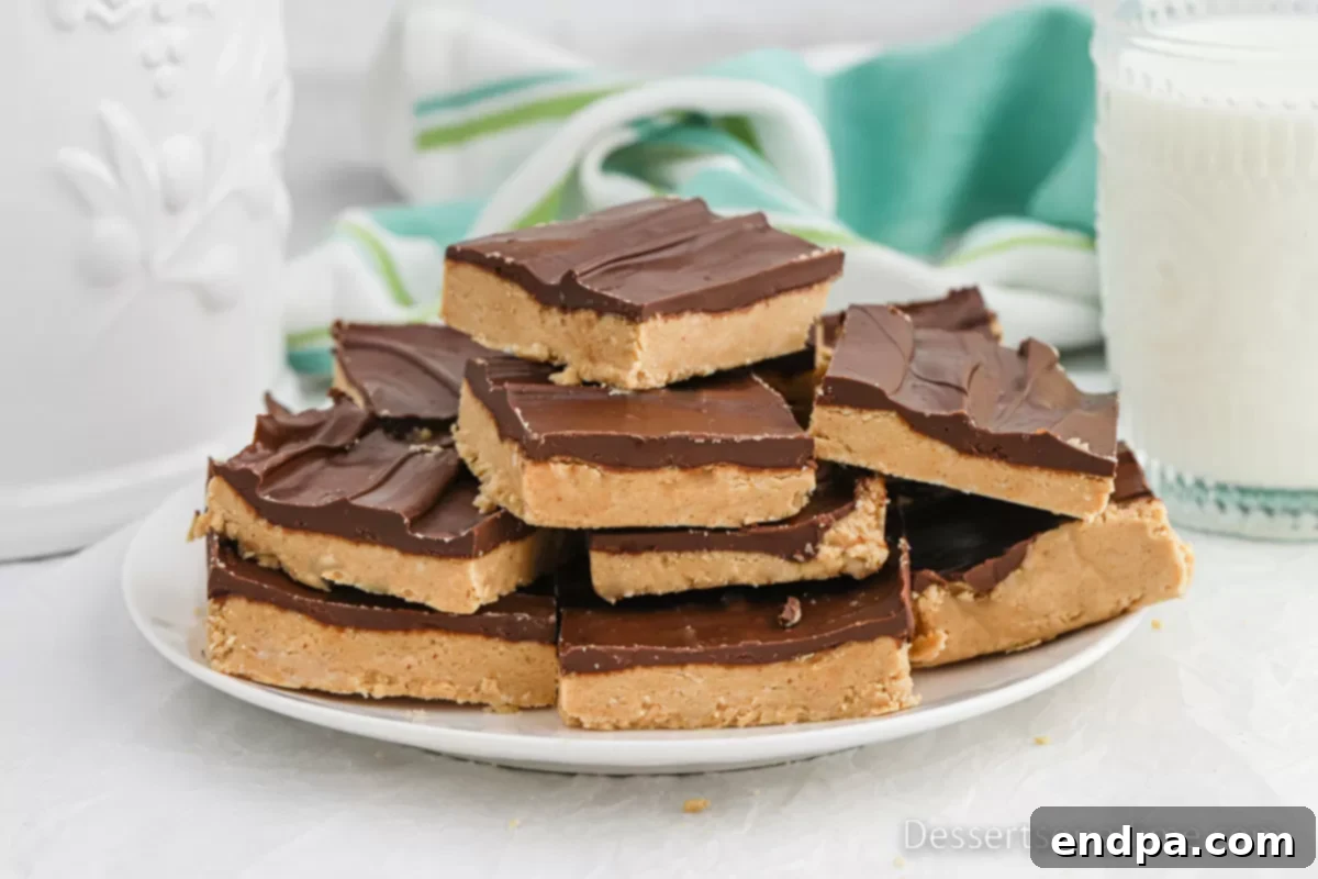 Buckeye Bars cut and served on a plate, showcasing the distinct layers.