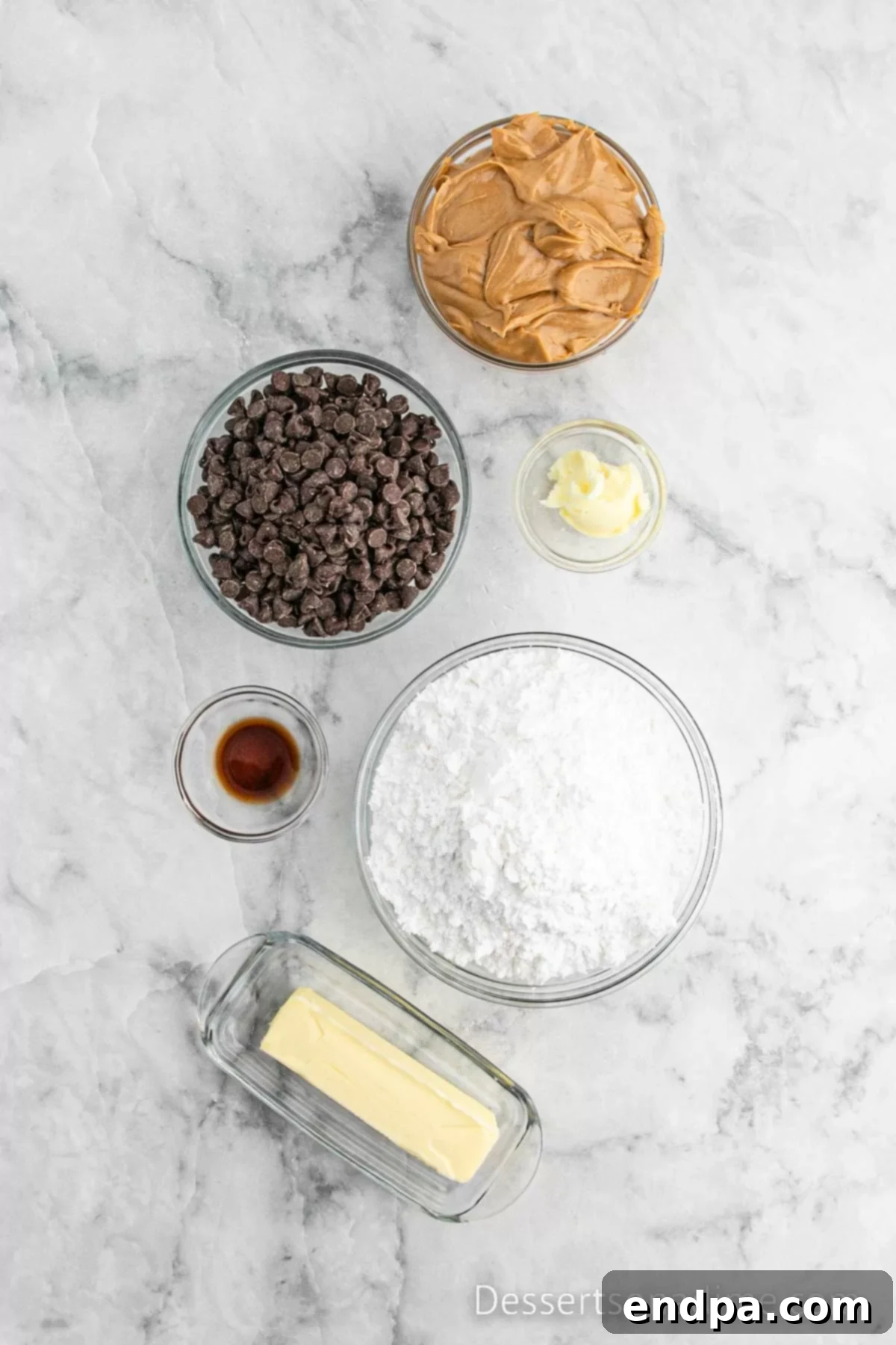 A flat lay image showing the simple ingredients needed for Buckeye Bars: butter, confectioners' sugar, creamy peanut butter, vanilla extract, chocolate chips, and shortening.