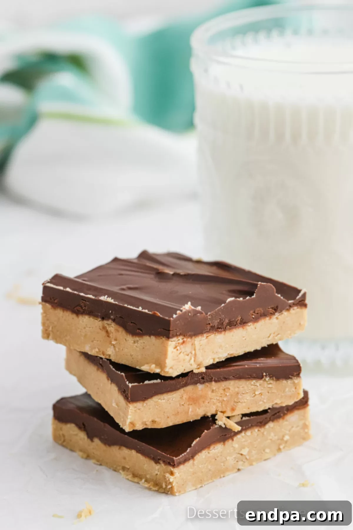 A close-up view of two neat stacks of Buckeye Bars, highlighting their distinct peanut butter and chocolate layers.