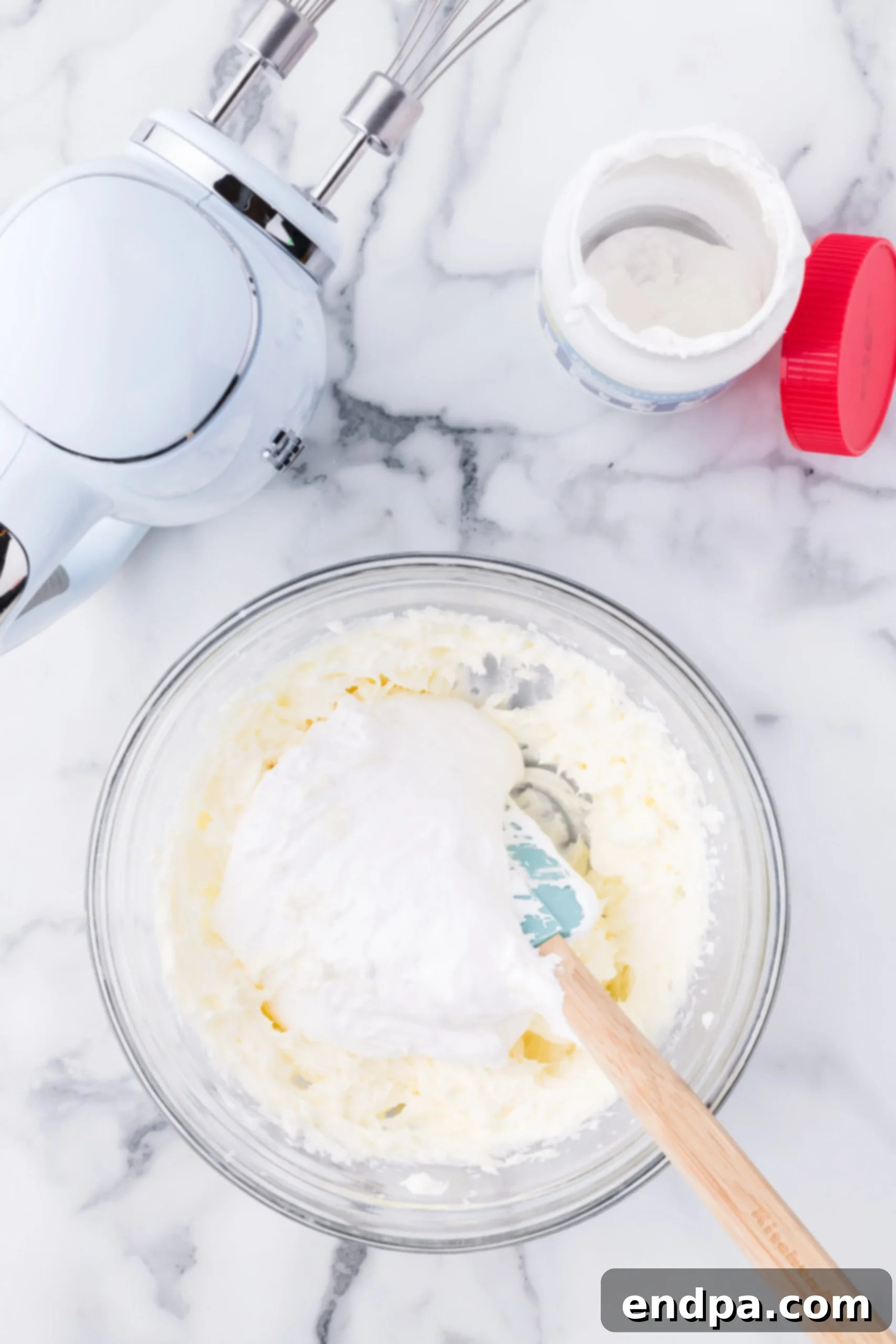 Mixing bowl with butter, powdered sugar and salt combined until fluffy.