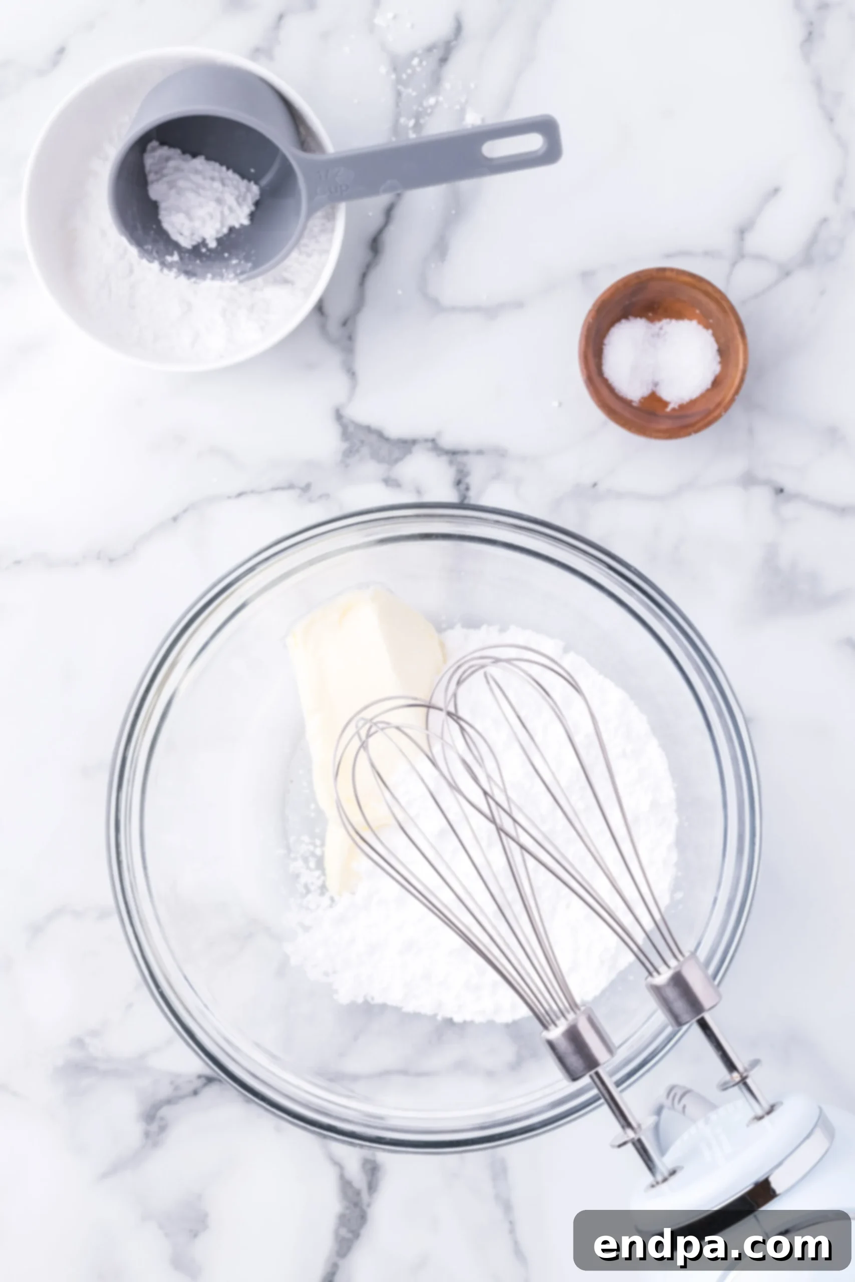 Mixing bowl with butter and powdered sugar.