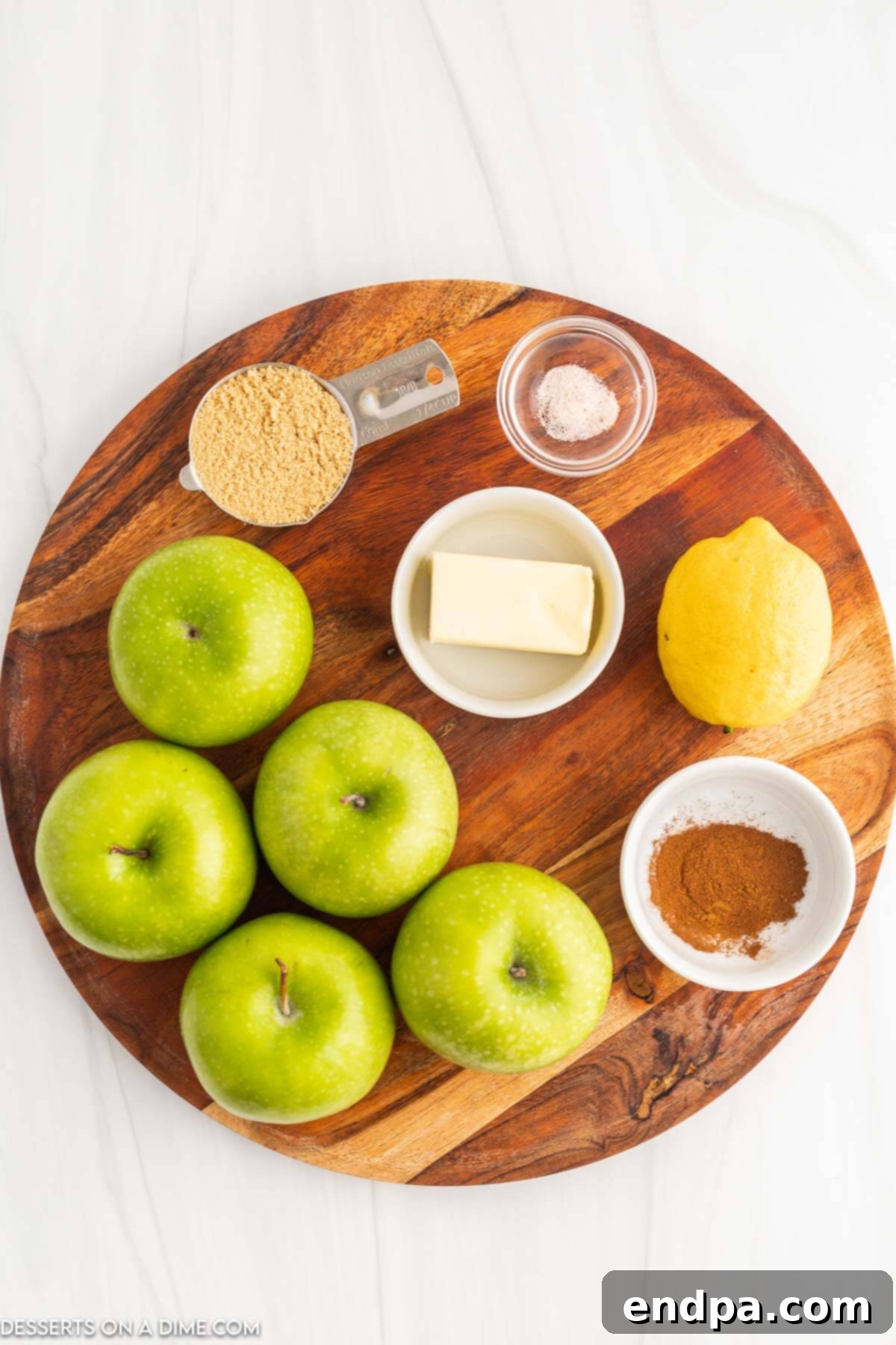 Key ingredients for homemade Cracker Barrel fried apples: fresh apples, butter, brown sugar, and lemon.