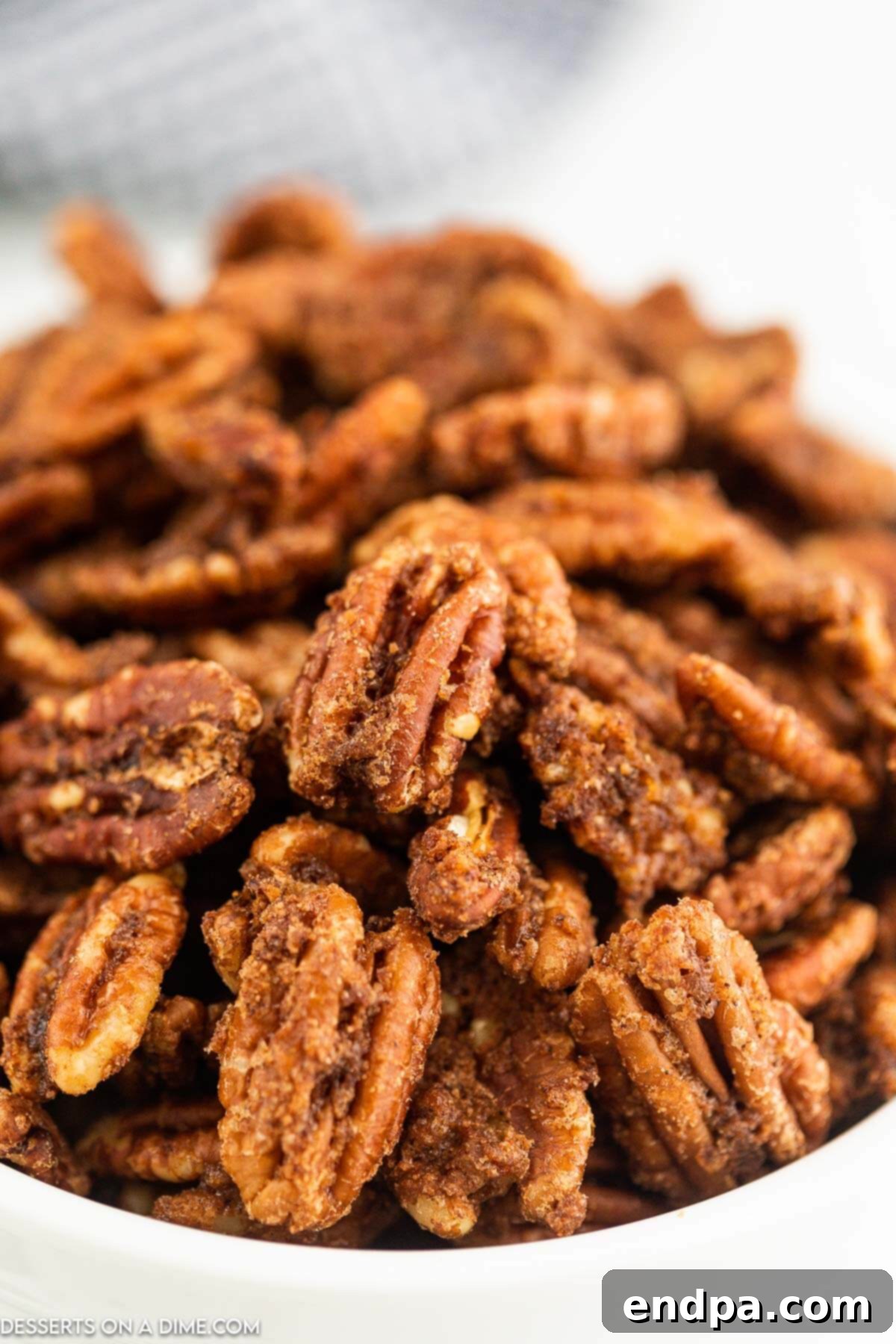 Irresistible Air Fryer Candied Pecans 2 Air fryer candied pecans in a bowl.