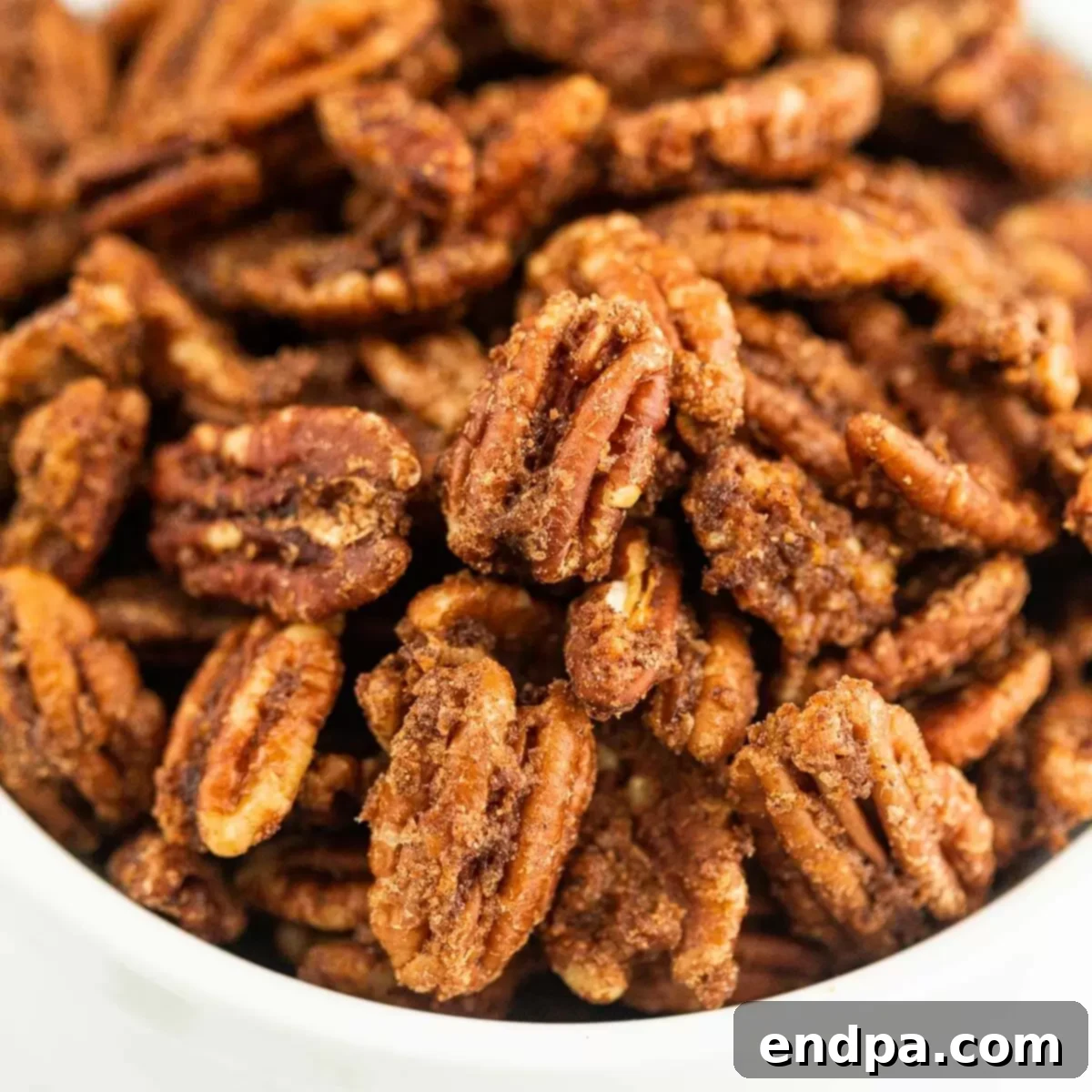 Irresistible Air Fryer Candied Pecans 11 Air fryer candied pecans in a bowl.