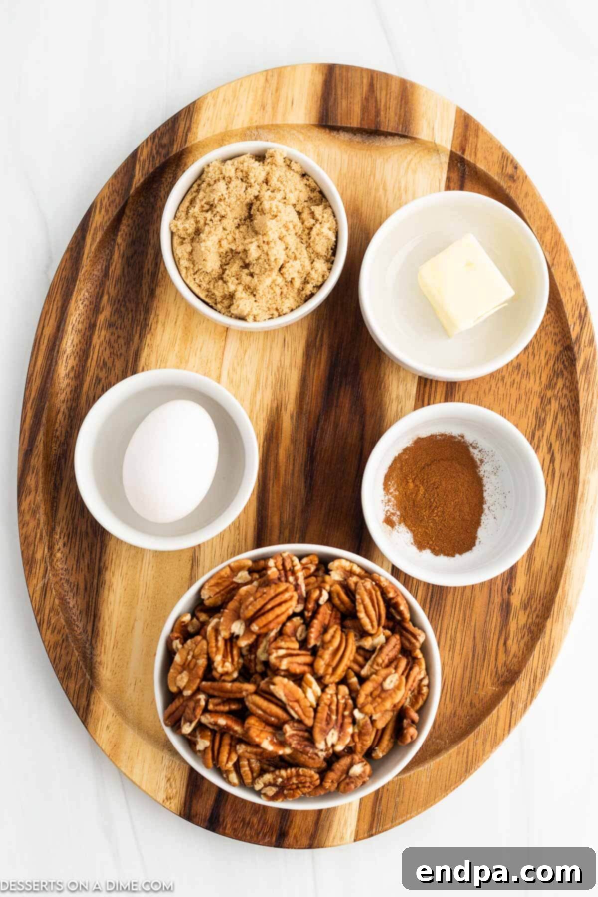 Irresistible Air Fryer Candied Pecans 3 Ingredients for Air fryer candied pecans. - pecan halves, butter, egg whites, brown sugar, cinnamon.
