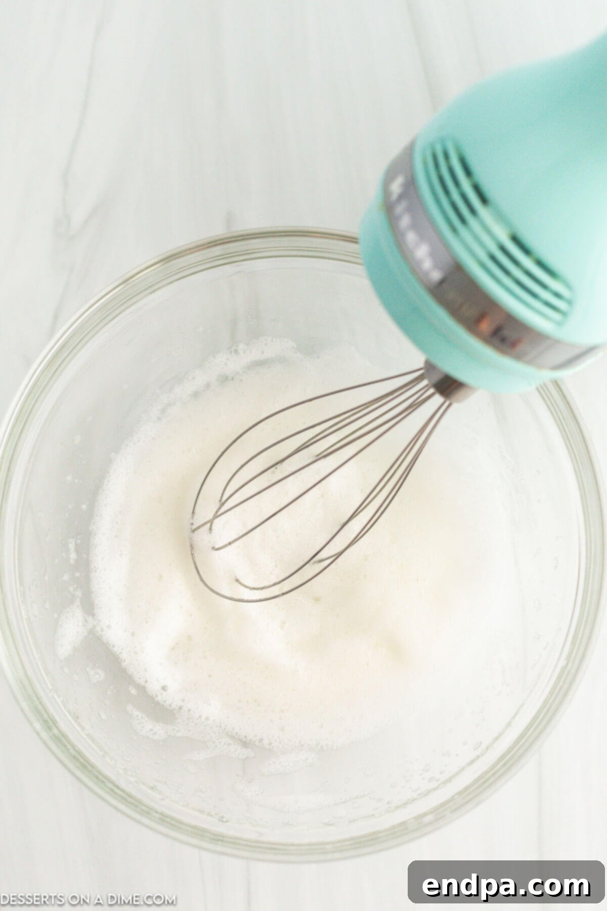 Irresistible Air Fryer Candied Pecans 4 Egg whites in a bowl being beat.