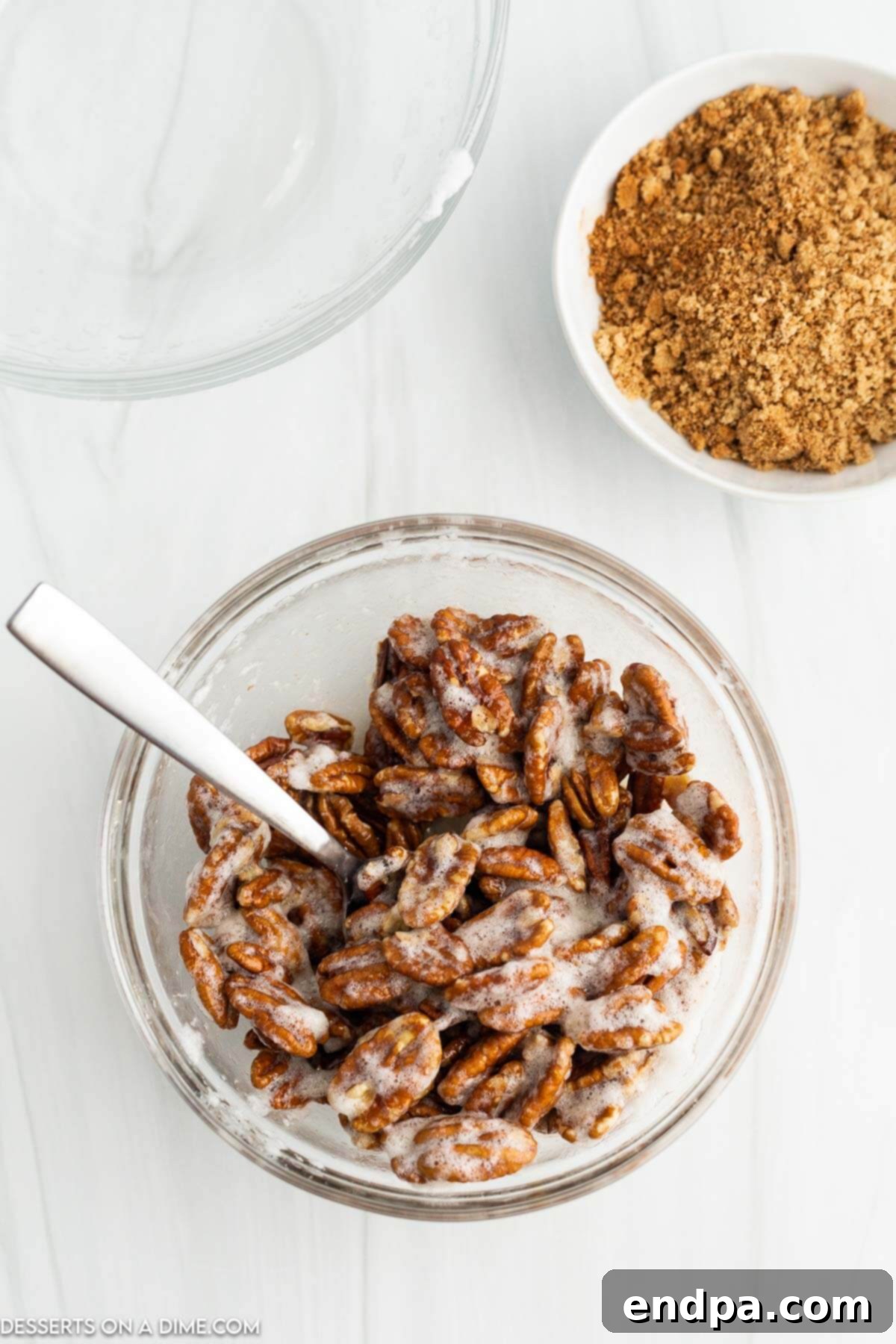 Irresistible Air Fryer Candied Pecans 5 Pecans coated in egg white mixture.