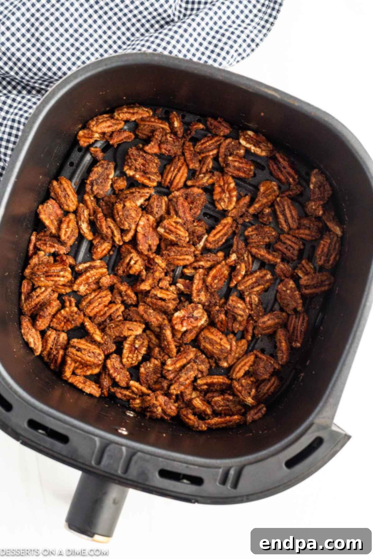 Irresistible Air Fryer Candied Pecans 7 Pecans in the air fryer basket.