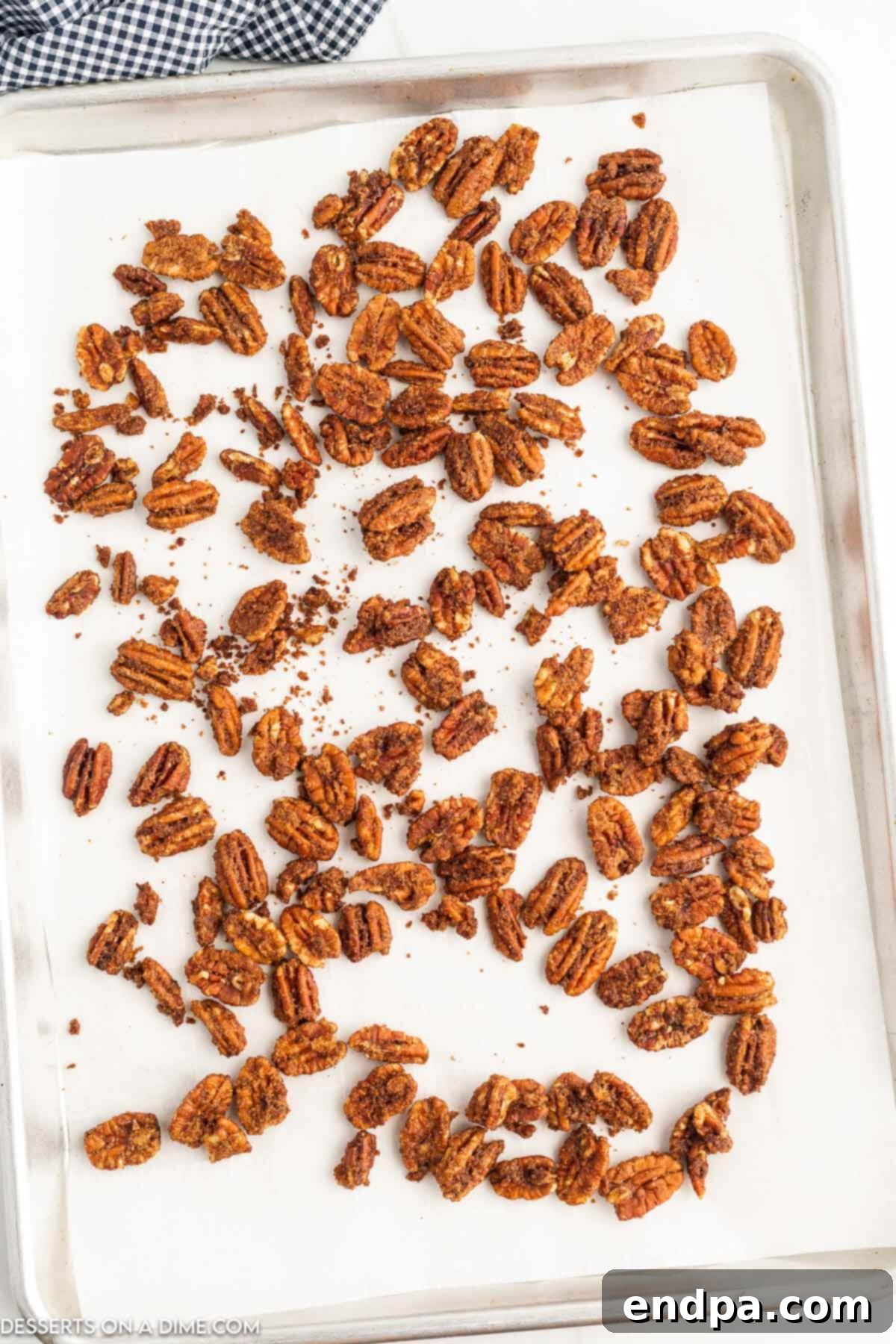 Irresistible Air Fryer Candied Pecans 8 Candied Pecans on a baking sheet cooling.