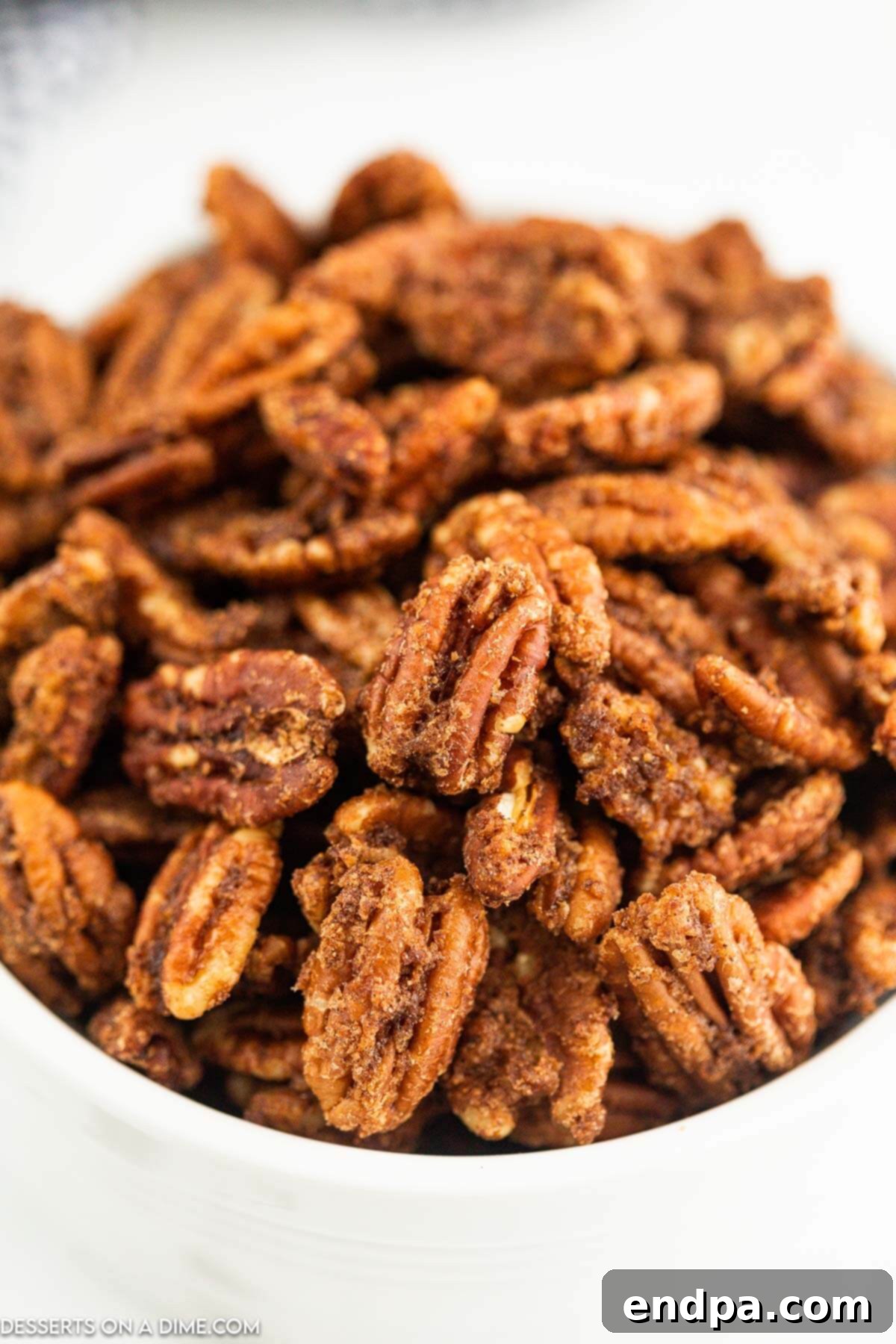 Irresistible Air Fryer Candied Pecans 9 Candied Pecans in a bowl.